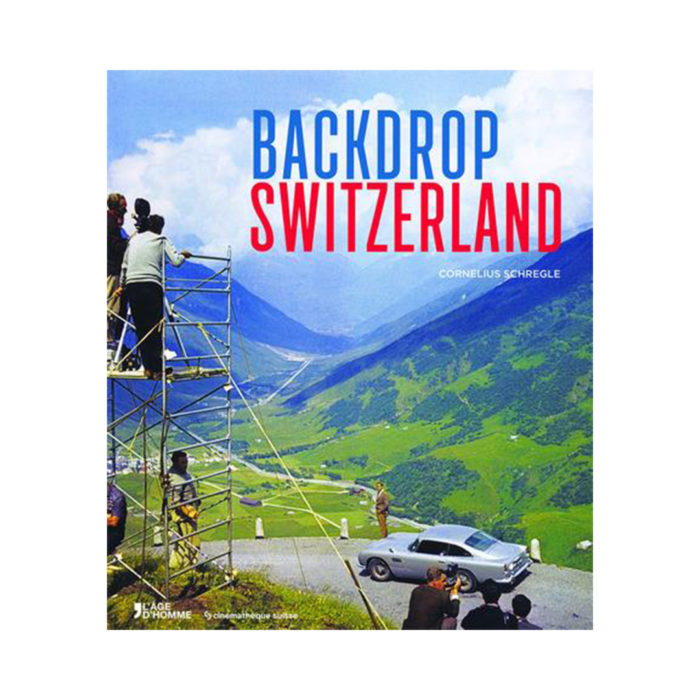 Poster for 'Backdrop Switzerland' showing crew on a scaffold filming a car scene against the Swiss Alps